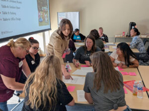Photograph of WIN House Miller Project staff at a table during an engagement exercise